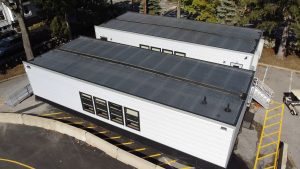 Aerial view of a triumph modular building showcasing its sleek design, representing modern modular construction techniques for both permanent and temporary modular buildings.