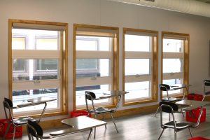 Classroom interior featuring large windows in a permanent modular building, showcasing the benefits of modular construction for educational spaces.