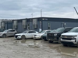 Parking lot view of construction site with modular buildings