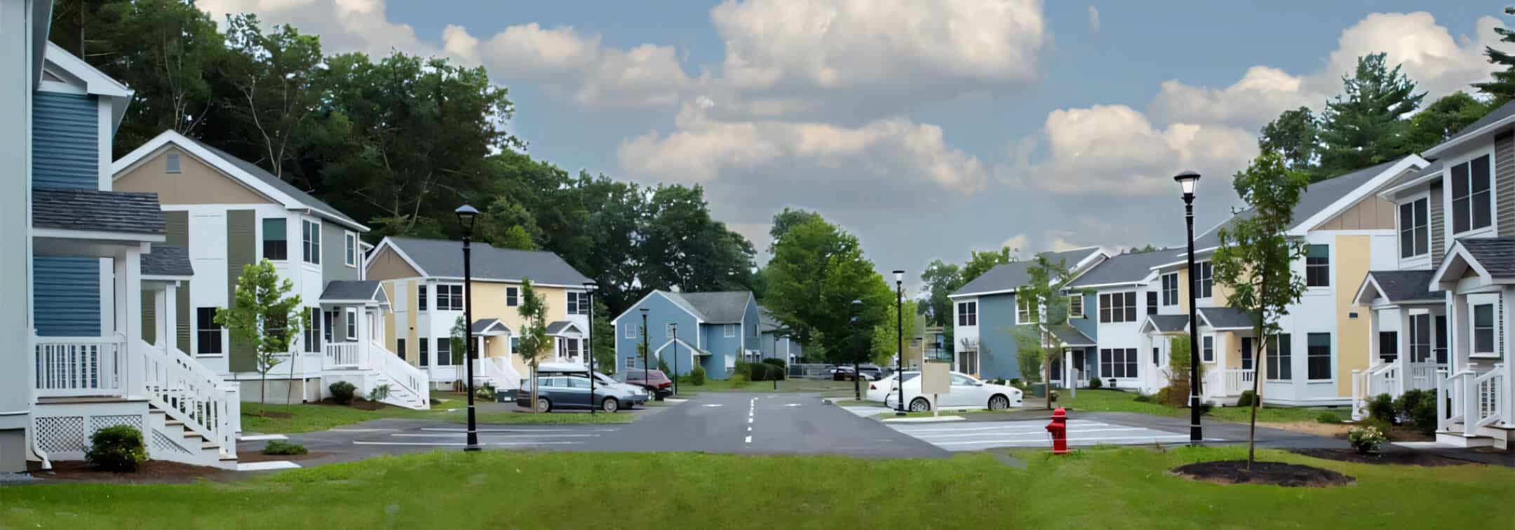 A row of colorful modular buildings with well-maintained landscaping and a clear blue sky, showcasing the concept of permanent modular building in a community setting.